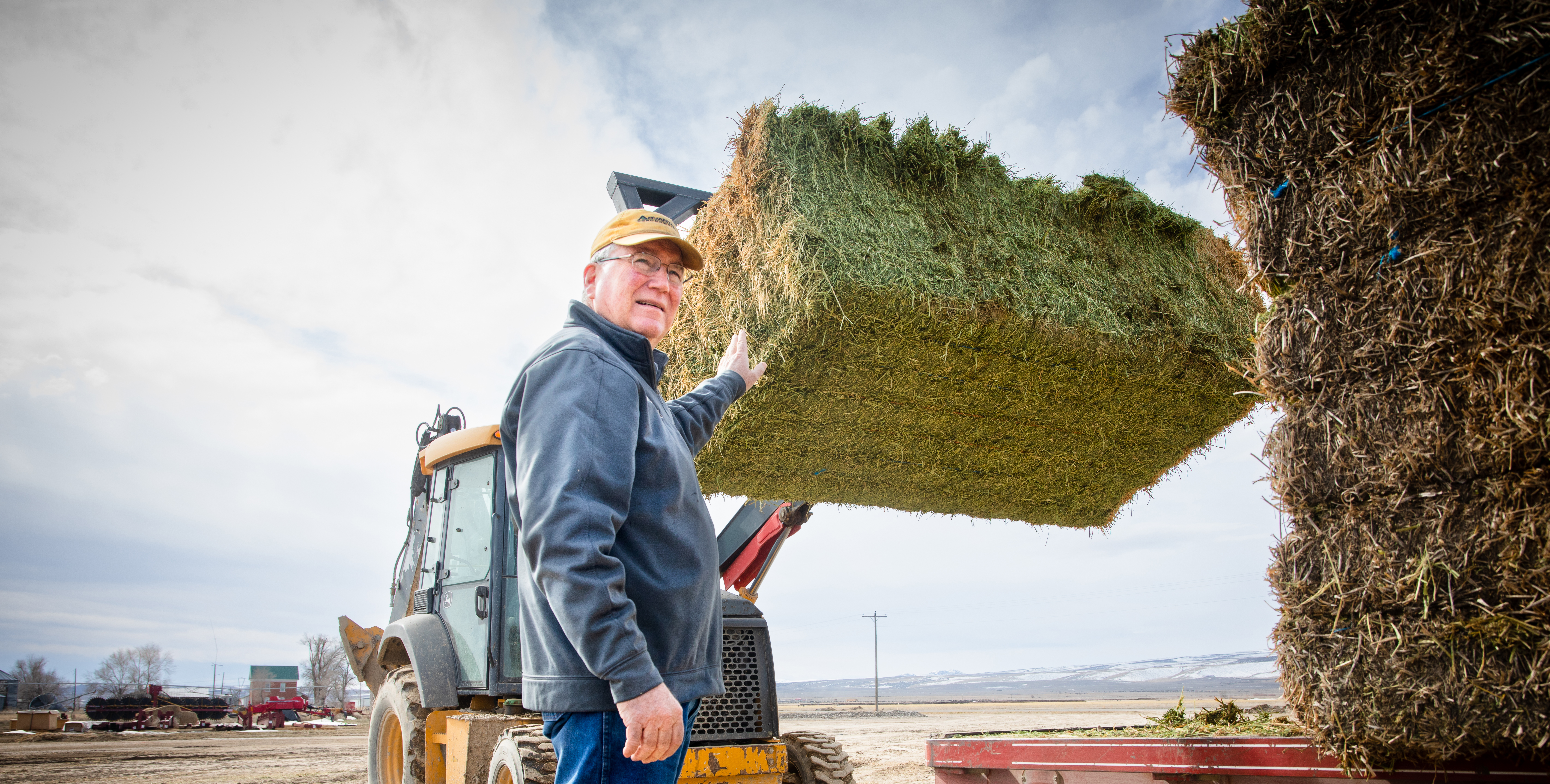 Scott Bedke with a hay bail